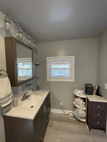 a en suite bathroom with a double vanity sink and a mirror