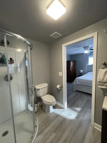 a bathroom with a toilet and a shower