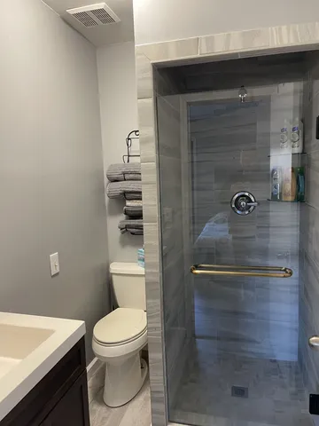 a bathroom with a toilet a sink and shower