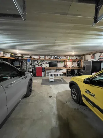 a view of parking garage with cars parked