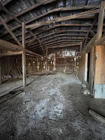 a view of an empty room with wooden walls