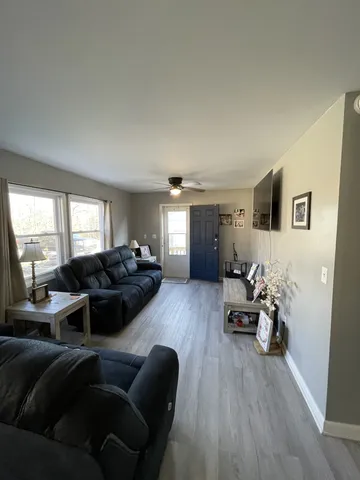 a living room with furniture window and wooden floor