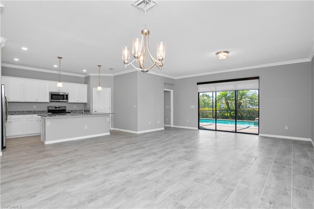 19952 Beverly Park Road Estero, FL 33928 - Photo 4 of 32 a view of an empty room and kitchen with window