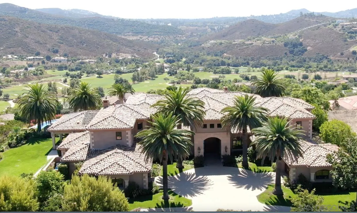 an aerial view of residential houses with yard and trees
