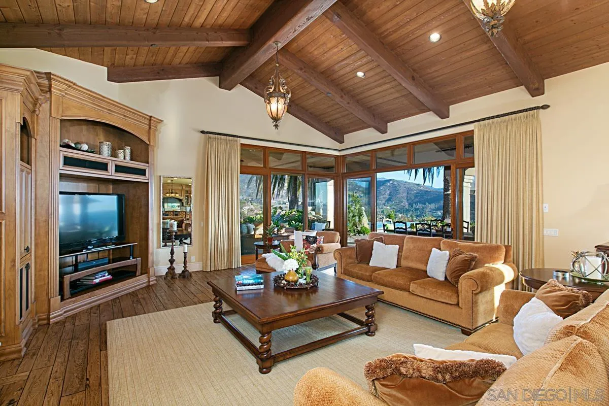 14155 Bryce Point Poway, CA 92064 - Photo 25 of 71 a living room with furniture a flat screen tv and a floor to ceiling window