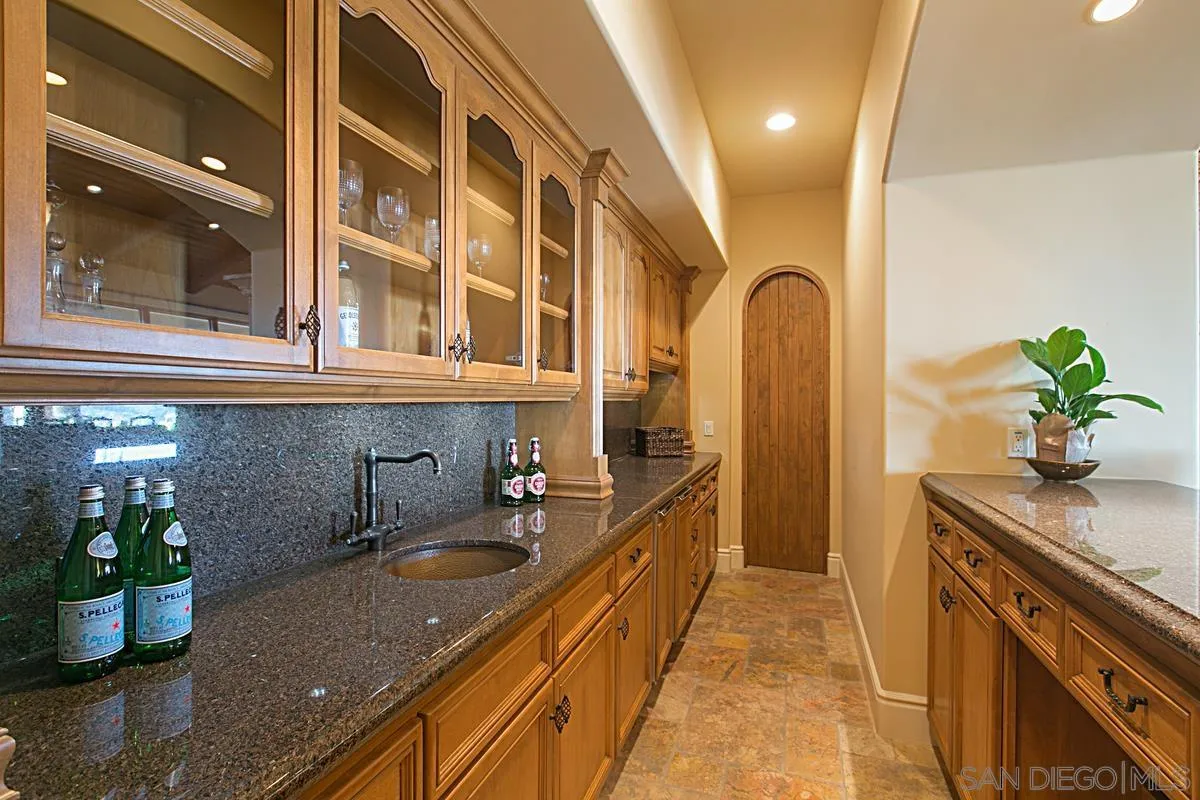 14155 Bryce Point Poway, CA 92064 - Photo 28 of 71 a kitchen with a sink and a refrigerator