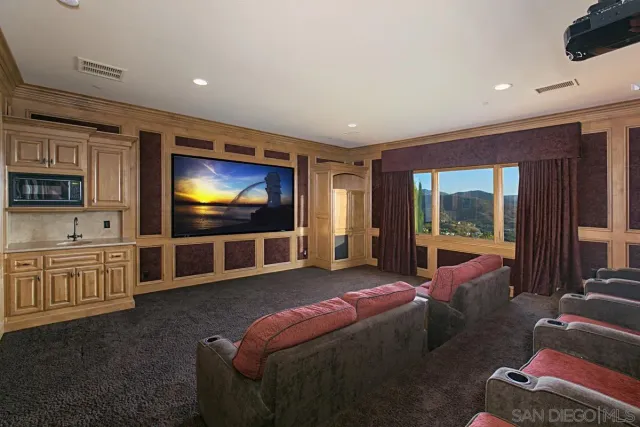 a bathroom with a granite countertop toilet sink and mirror