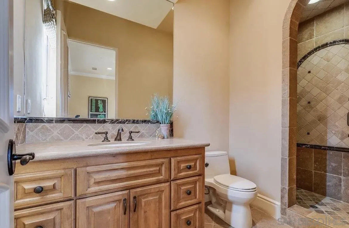 14155 Bryce Point Poway, CA 92064 - Photo 42 of 71 a bathroom with a granite countertop toilet sink and mirror
