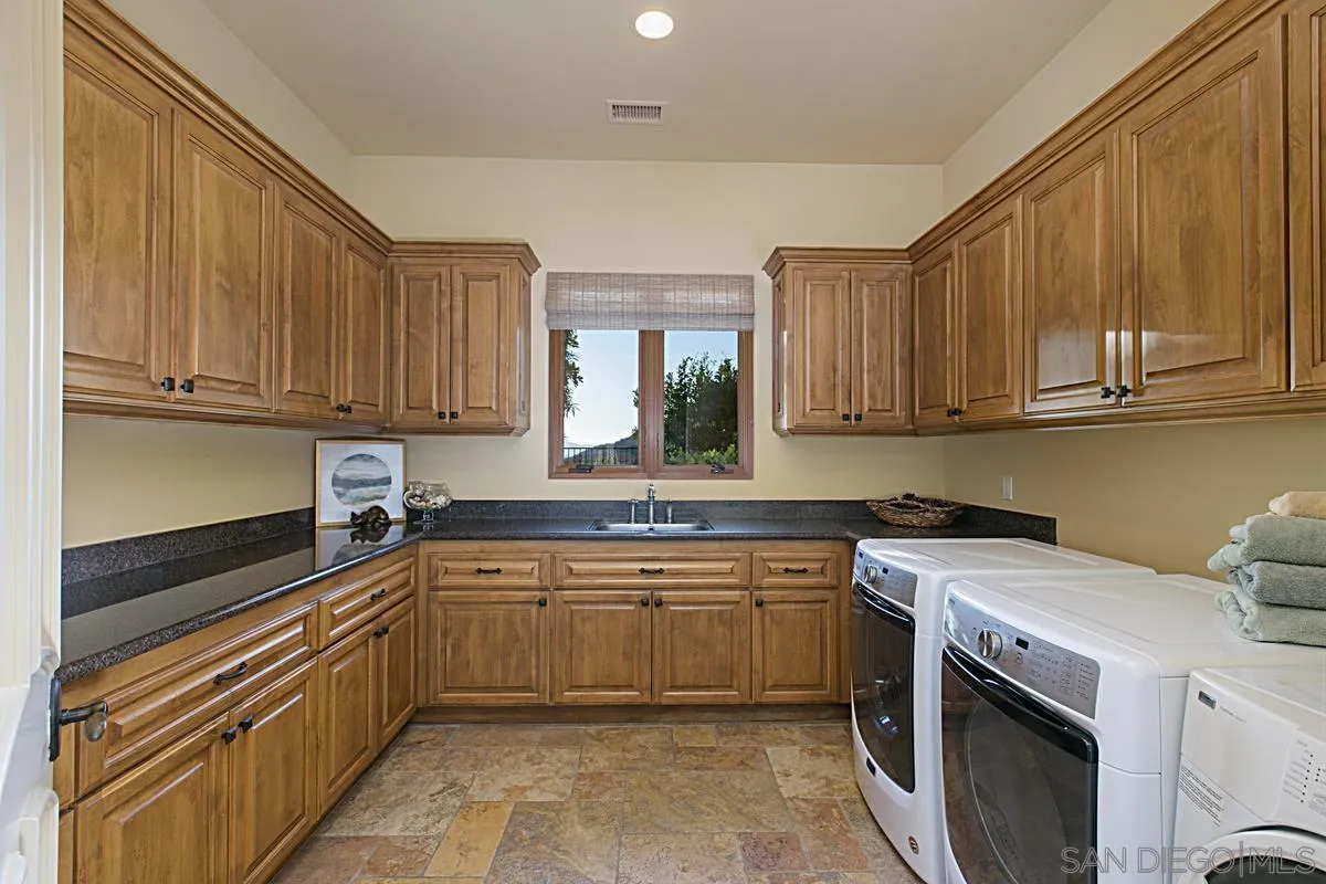 14155 Bryce Point Poway, CA 92064 - Photo 50 of 71 a kitchen with a sink stove and cabinets