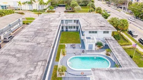 an aerial view of a house with a swimming pool