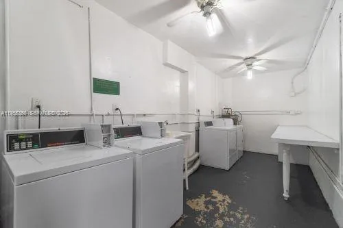 a view of storage and utility room with a washer dryer and a chandelier