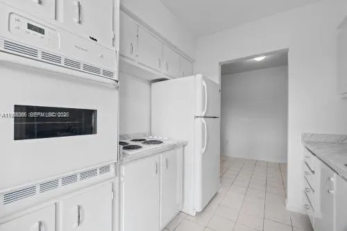 a kitchen with stainless steel appliances a refrigerator and a stove top oven