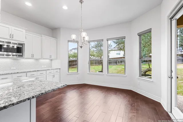 a view of a kitchen with a sink wooden floor and windows