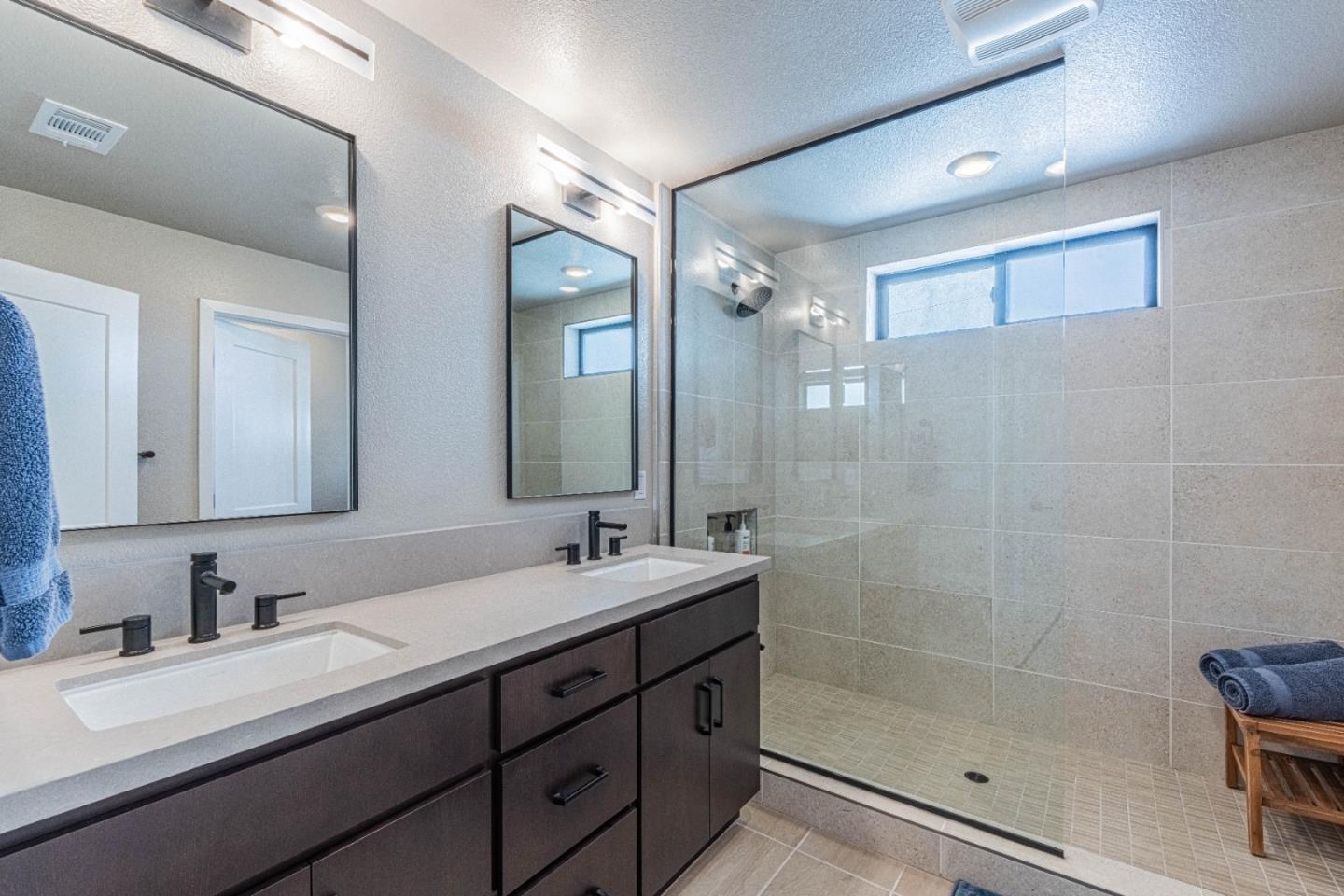 135 8th Street Marina, CA 93933 - Photo 46 of 69 a bathroom with a shower sink and mirror