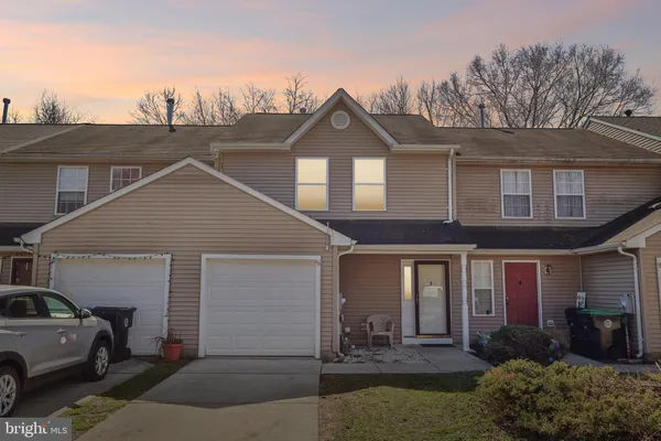 a view of a house with a yard and garage