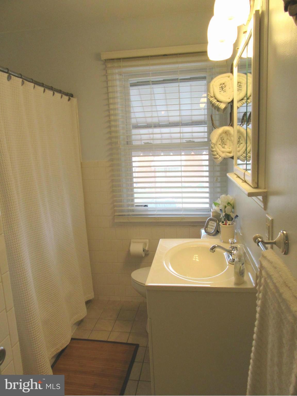 1726 Stokesley Road Baltimore, MD 21222 - Photo 11 of 23 a bathroom with a sink and a mirror