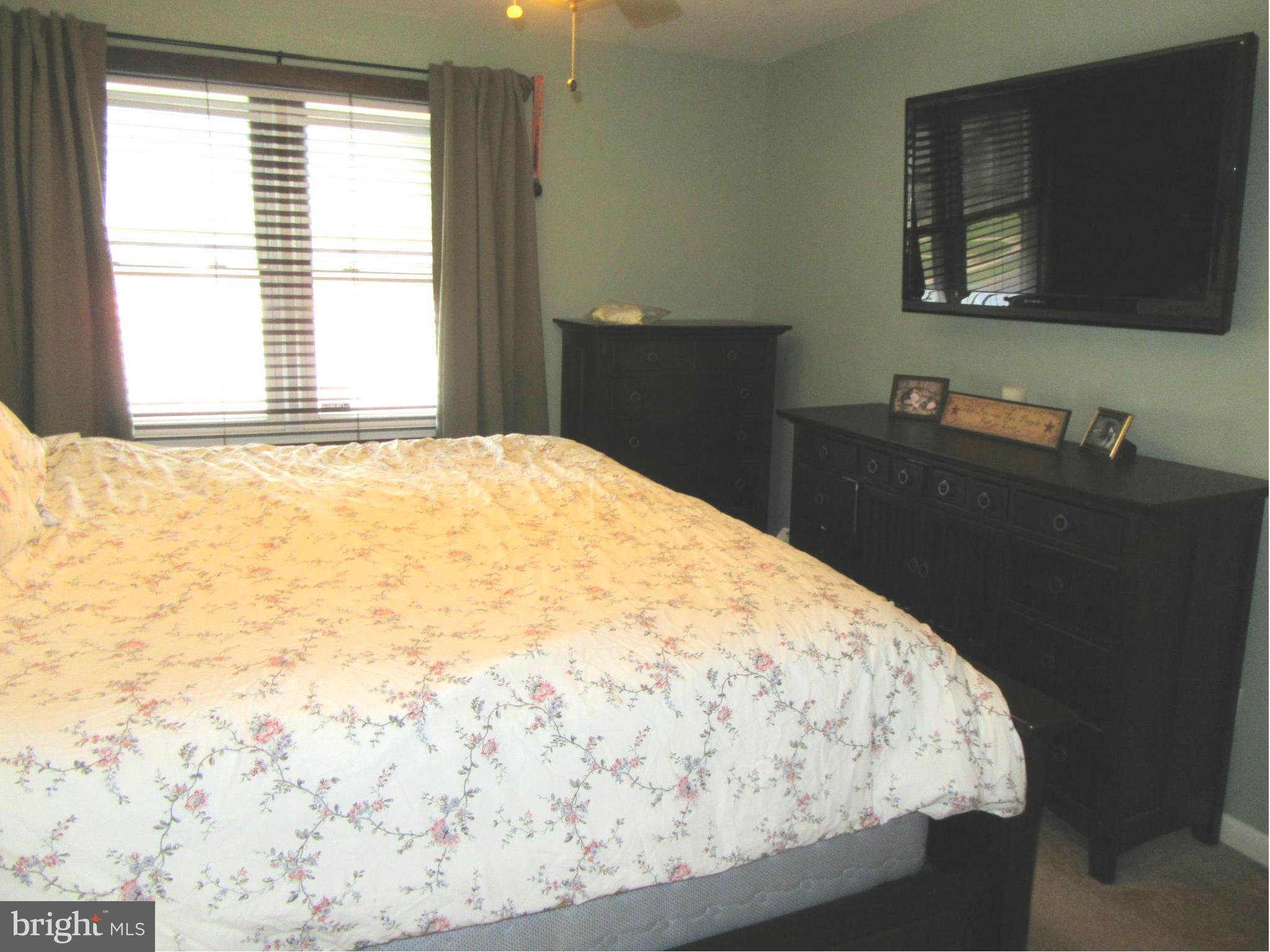 1726 Stokesley Road Baltimore, MD 21222 - Photo 15 of 23 a bedroom with a bed and a flat screen tv