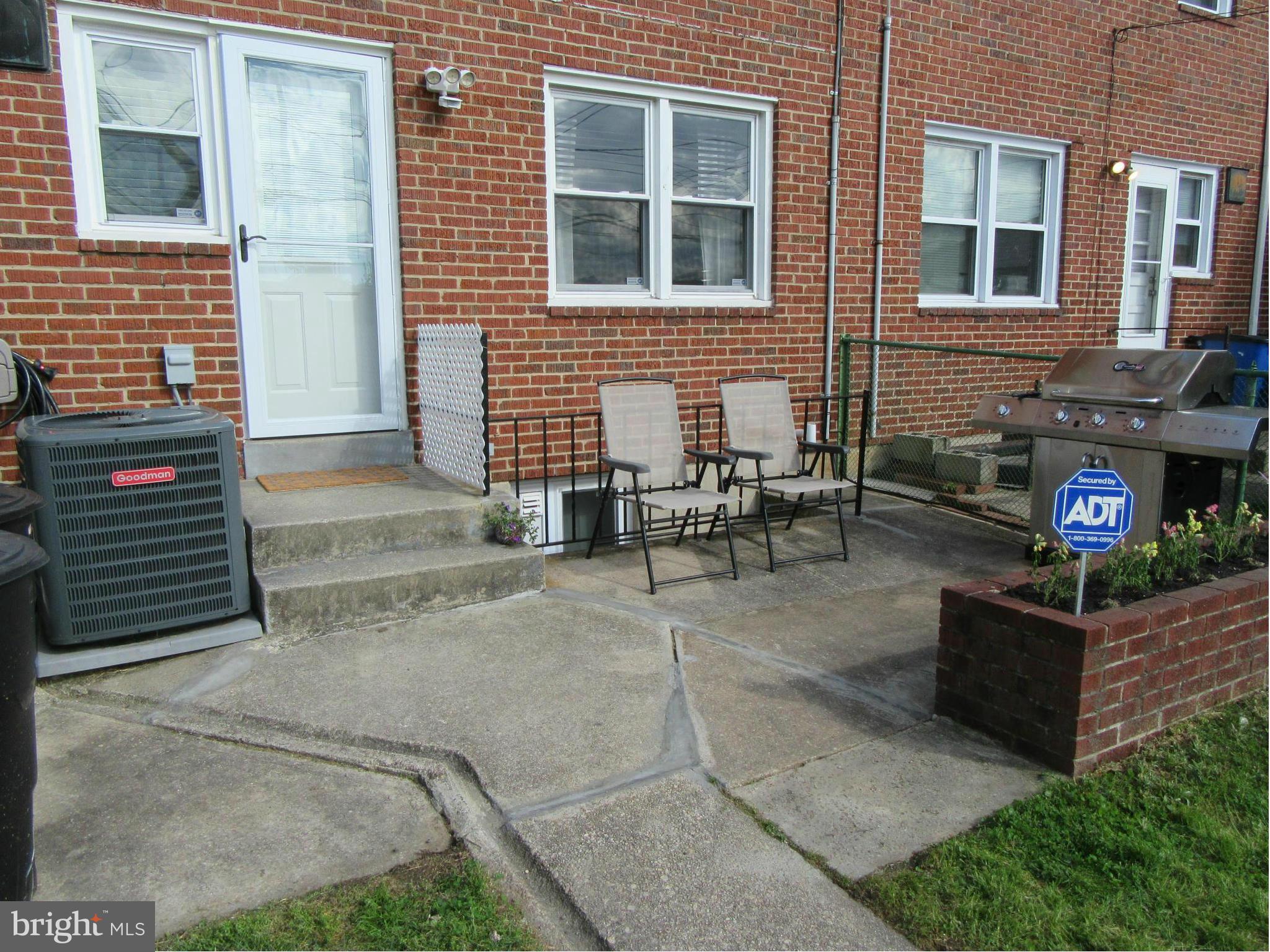 1726 Stokesley Road Baltimore, MD 21222 - Photo 20 of 23 a view of a brick house with a bench in front of building