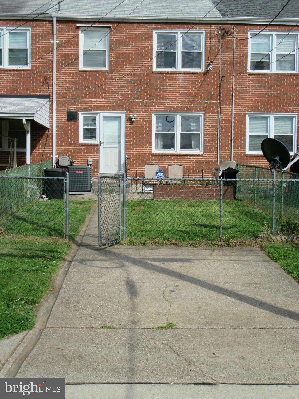 1726 Stokesley Road Baltimore, MD 21222 - Photo 21 of 23 a view of a brick house with a yard and plants