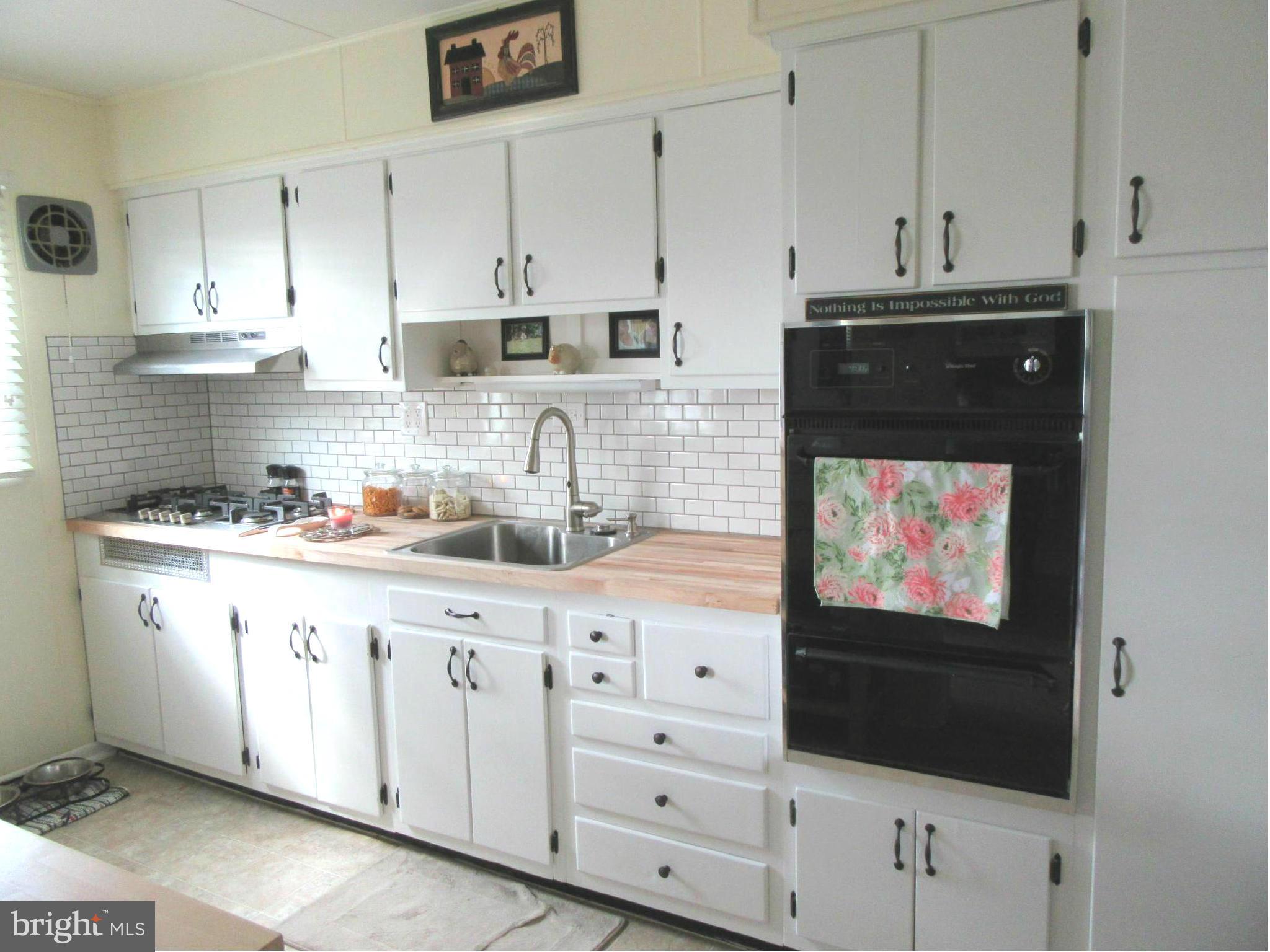 1726 Stokesley Road Baltimore, MD 21222 - Photo 4 of 23 a kitchen with granite countertop white cabinets and stainless steel appliances