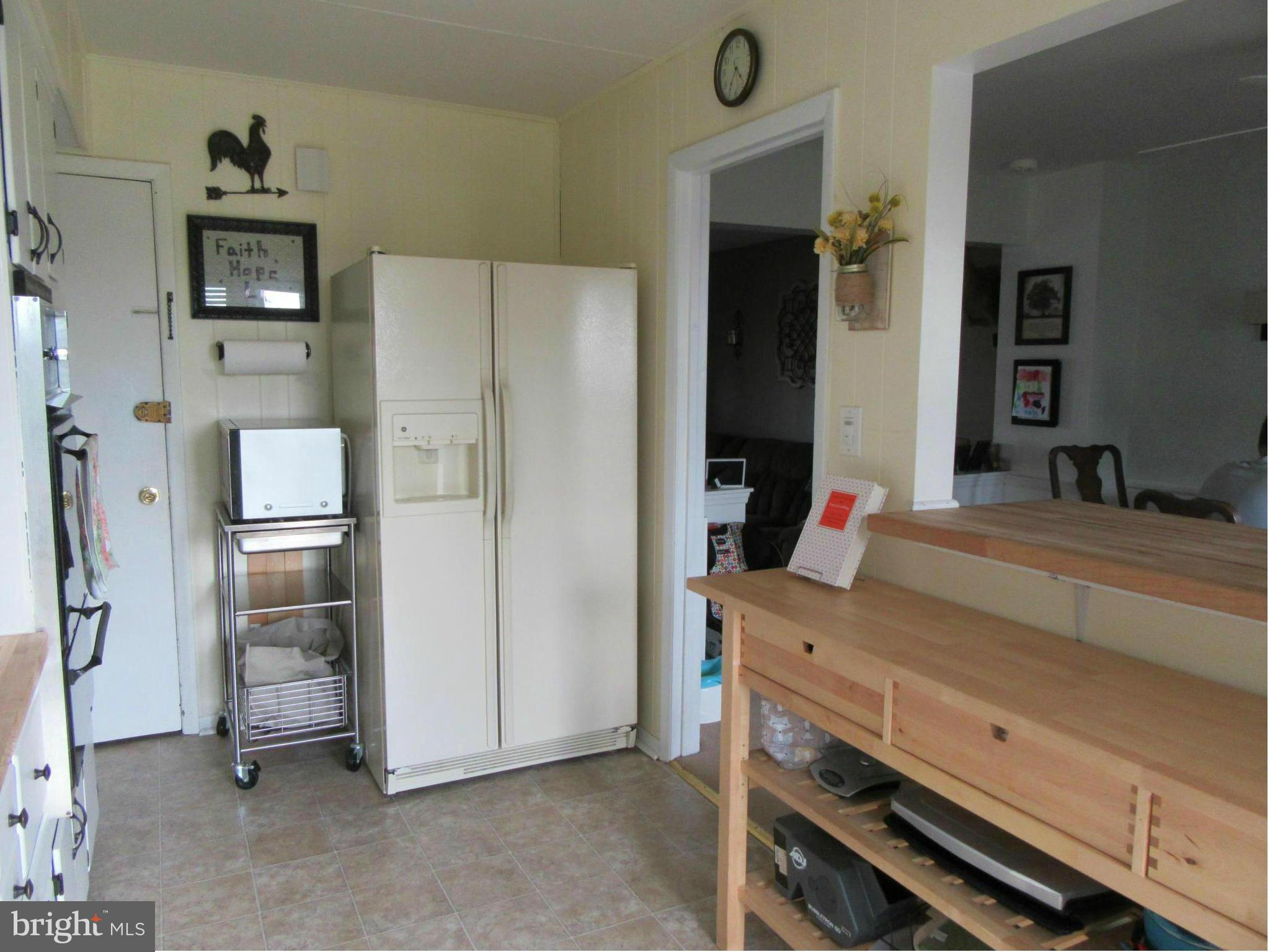1726 Stokesley Road Baltimore, MD 21222 - Photo 6 of 23 a kitchen with a refrigerator and countertop