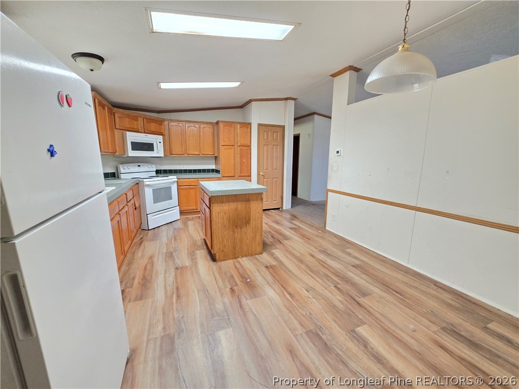 124 Franklin Road Raeford, NC 28376 - Photo 7 of 15 a kitchen with stainless steel appliances granite countertop a refrigerator a stove and a wooden floors