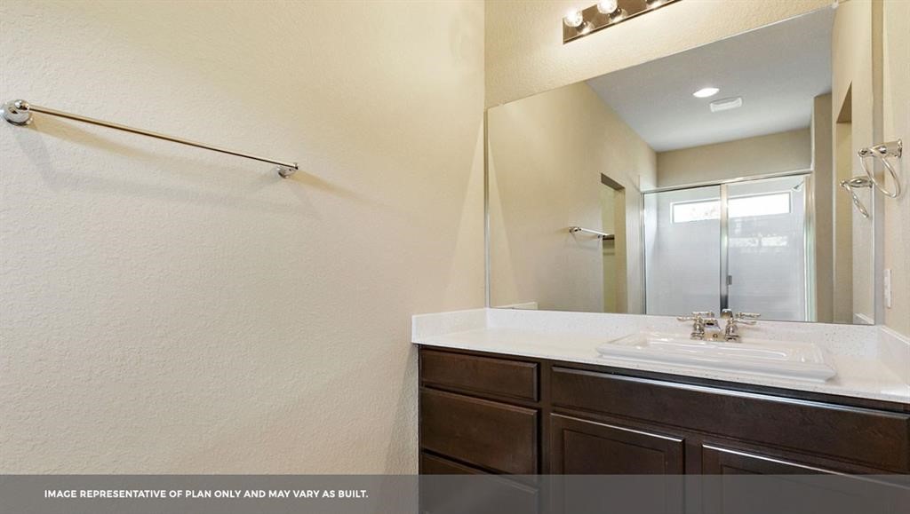 14909 Custis Lane Austin, TX 78725 - Photo 12 of 21 a bathroom with a sink and mirror