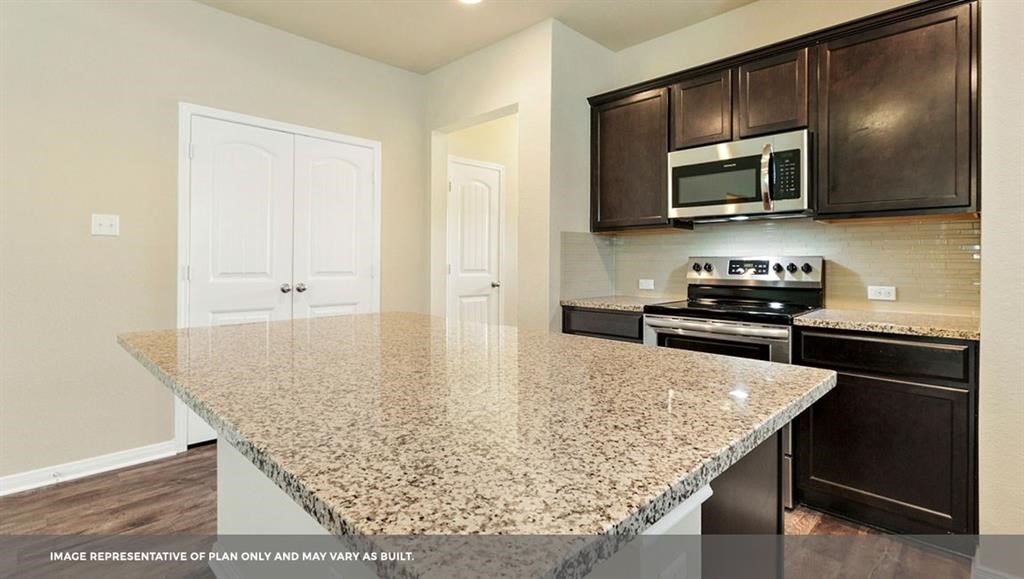 14909 Custis Lane Austin, TX 78725 - Photo 15 of 21 a kitchen with stainless steel appliances granite countertop a sink and microwave
