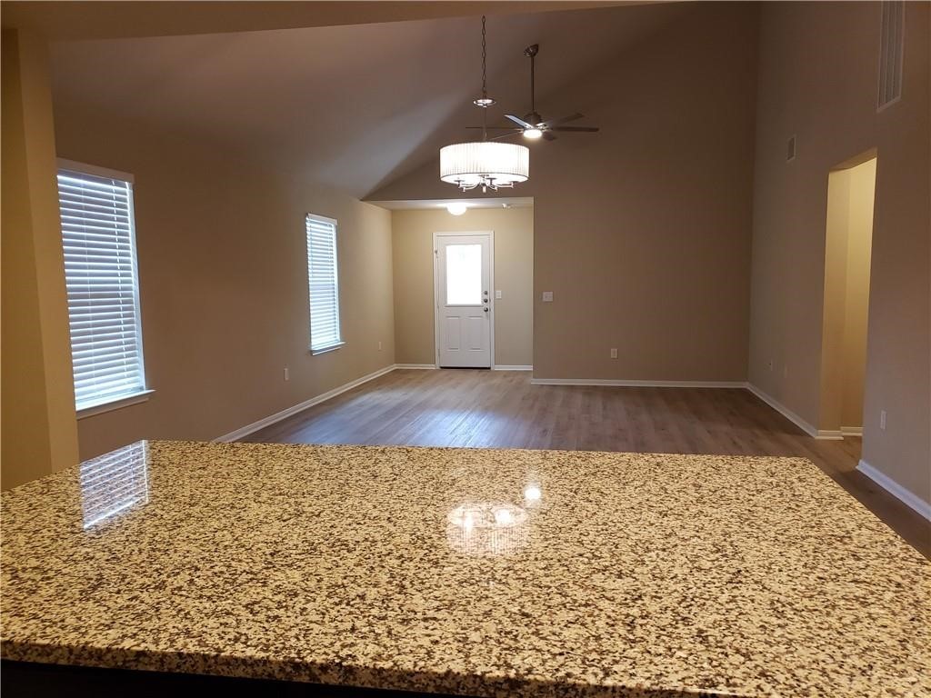 14909 Custis Lane Austin, TX 78725 - Photo 4 of 21 an empty room with wooden floor and windows