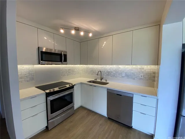 a kitchen with granite countertop a stove and a sink