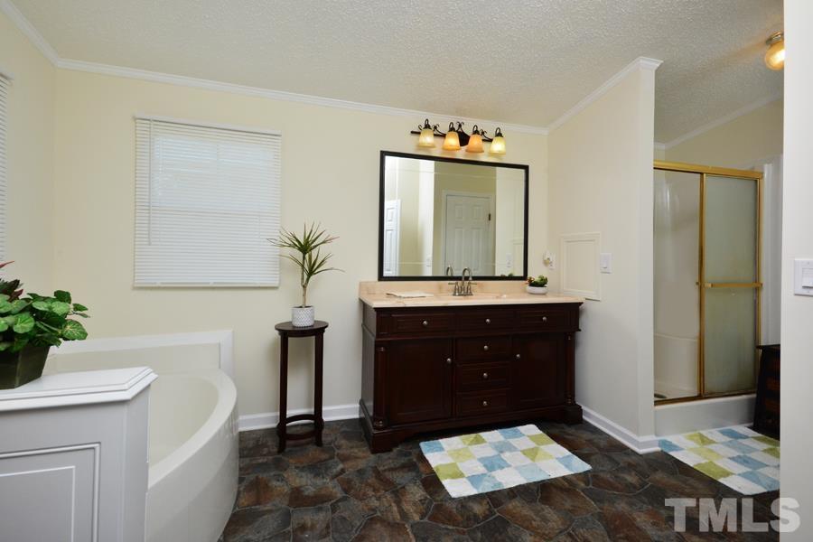 548 Duke Drive Rougemont, NC 27572 - Photo 12 of 43 a bathroom with a sink a vanity and a mirror