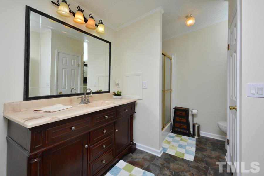 548 Duke Drive Rougemont, NC 27572 - Photo 13 of 43 a bathroom with a sink vanity and a mirror
