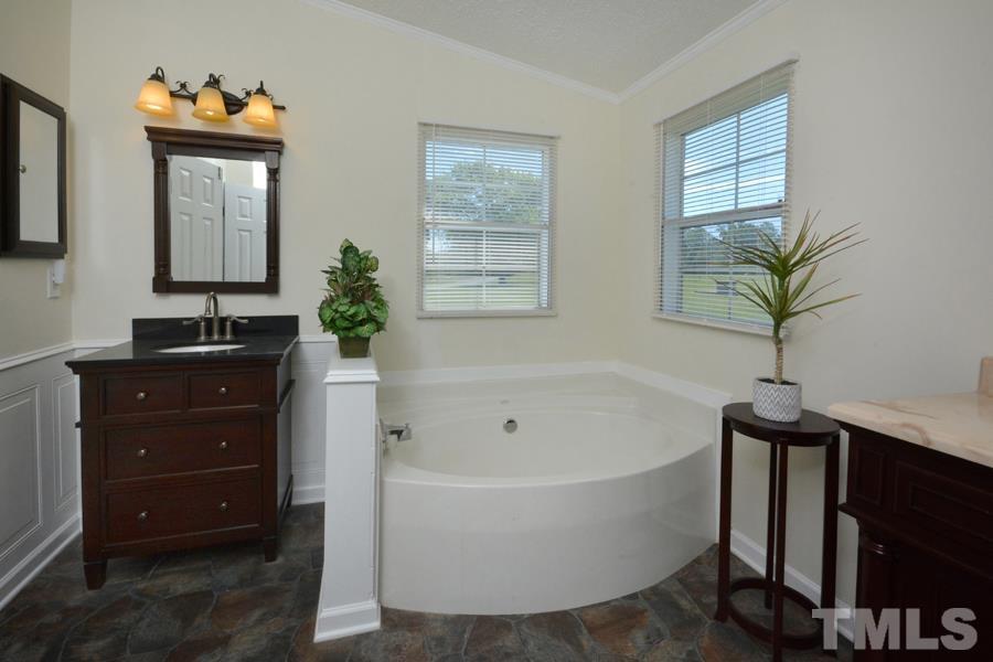 548 Duke Drive Rougemont, NC 27572 - Photo 14 of 43 a bathroom with a bathtub a sink and a mirror