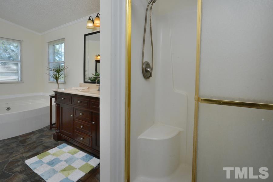 548 Duke Drive Rougemont, NC 27572 - Photo 16 of 43 a bathroom with a sink a mirror and a shower