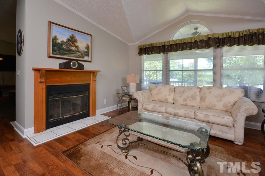 548 Duke Drive Rougemont, NC 27572 - Photo 17 of 43 a living room with furniture a large window and a fireplace