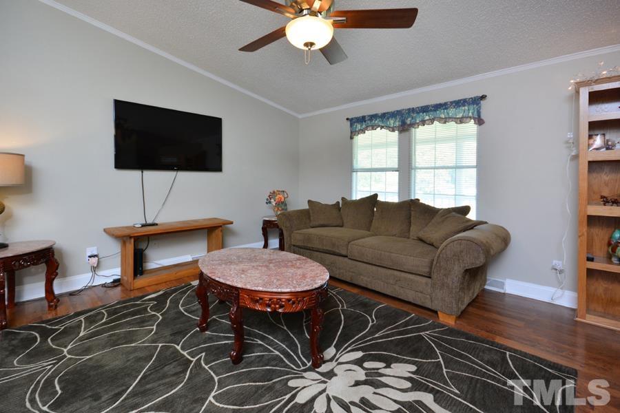 548 Duke Drive Rougemont, NC 27572 - Photo 19 of 43 a living room with furniture a flat screen tv and a window
