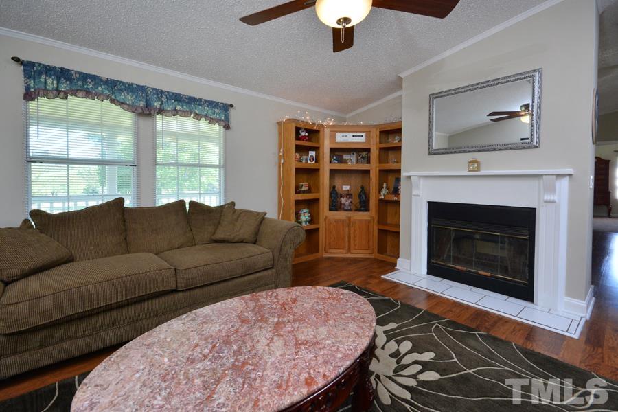 548 Duke Drive Rougemont, NC 27572 - Photo 20 of 43 a living room with furniture a window and a fireplace