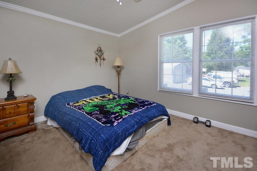 548 Duke Drive Rougemont, NC 27572 - Photo 22 of 43 a bedroom with a bed window and a dresser in it