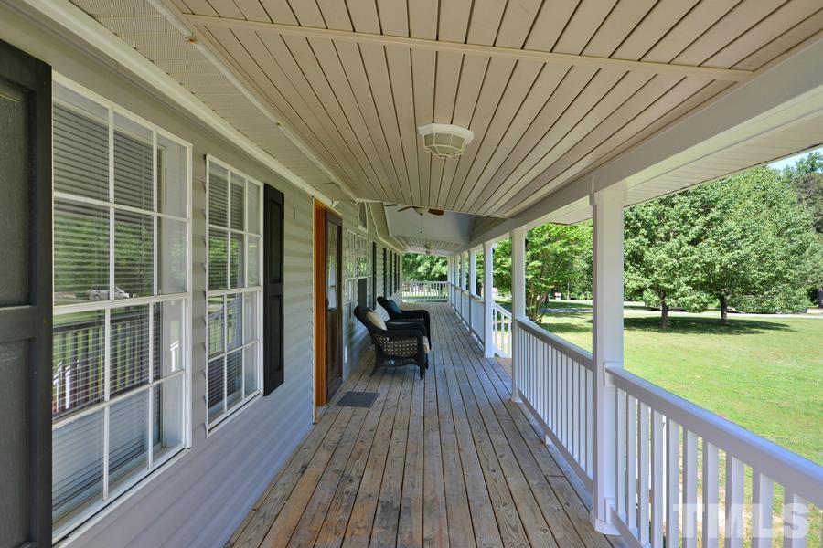 548 Duke Drive Rougemont, NC 27572 - Photo 29 of 43 a view of a balcony with chairs and wooden floor