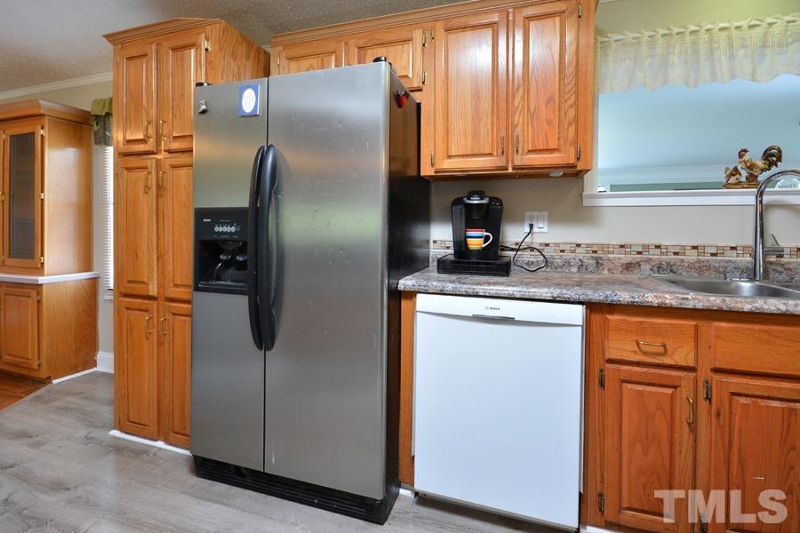 548 Duke Drive Rougemont, NC 27572 - Photo 3 of 43 a kitchen with stainless steel appliances granite countertop a refrigerator a sink and dishwasher