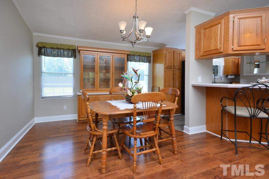548 Duke Drive Rougemont, NC 27572 - Photo 6 of 43 a dining room with furniture a chandelier and wooden floor