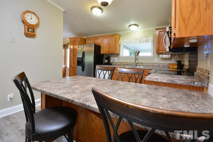 548 Duke Drive Rougemont, NC 27572 - Photo 9 of 43 a dining table with chairs and kitchen view