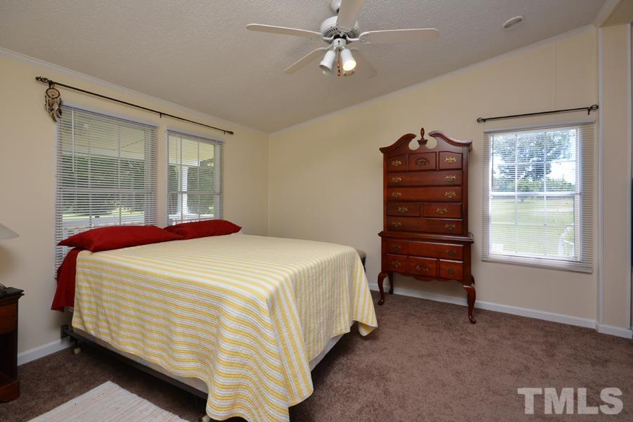 548 Duke Drive Rougemont, NC 27572 - Photo 10 of 43 a bedroom with a bed dresser and a window