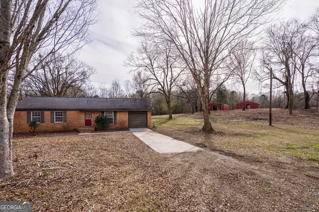 a view of a house with a yard covered in snow