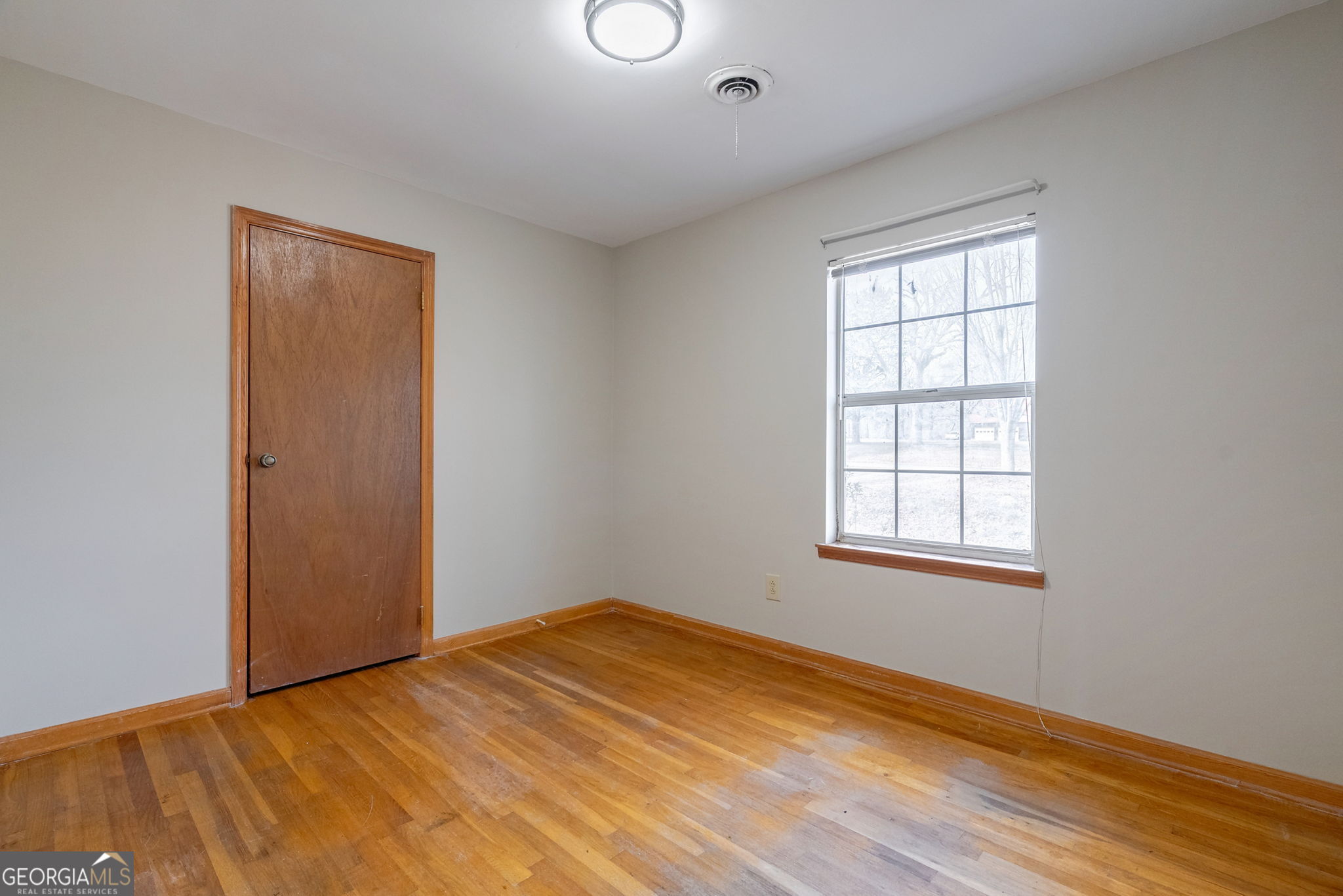 252 Raytown Road Northeast Crawfordville, GA 30631 - Photo 16 of 36 an empty room with wooden floor and windows