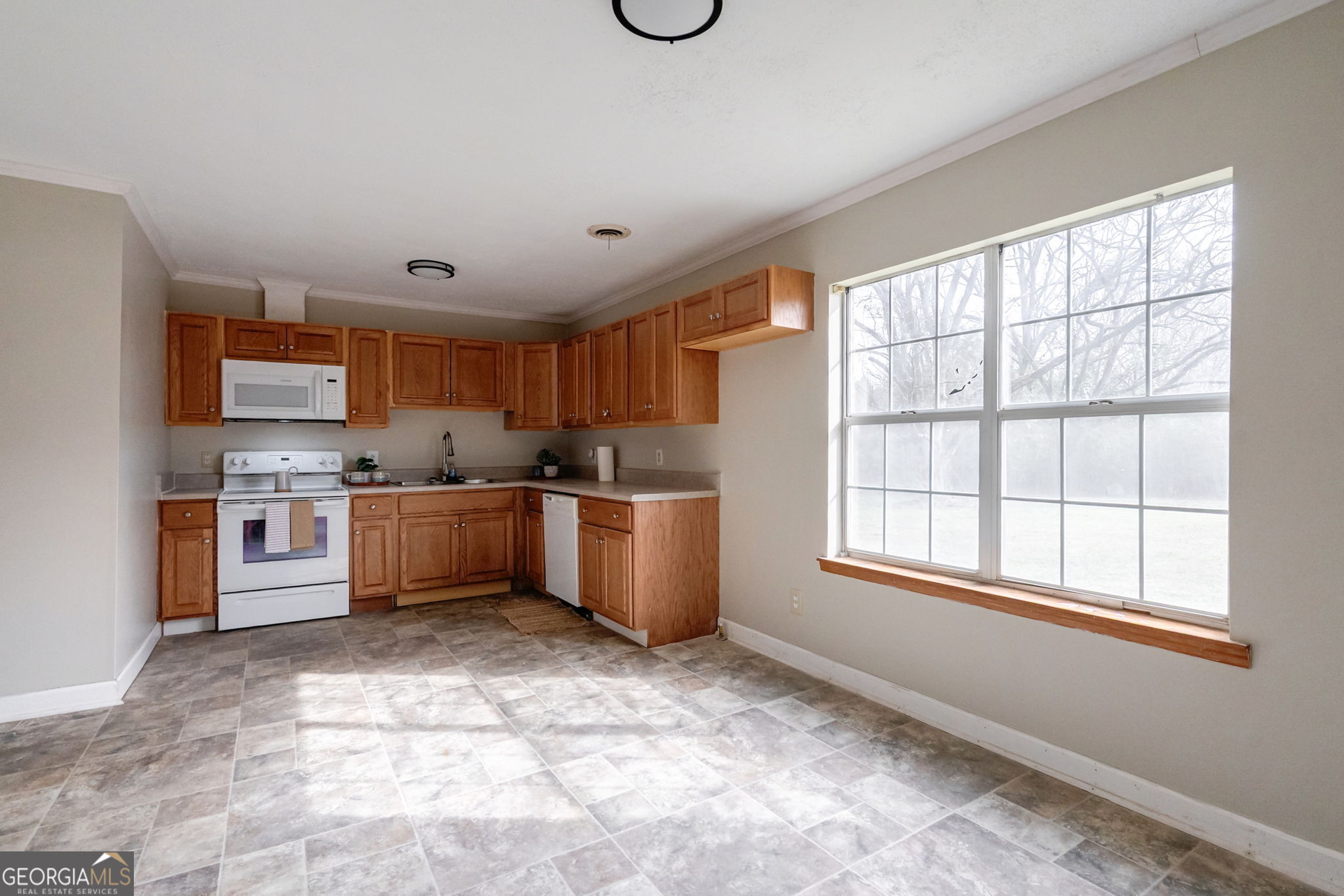 252 Raytown Road Northeast Crawfordville, GA 30631 - Photo 18 of 36 a kitchen with stainless steel appliances granite countertop a stove a sink and a refrigerator