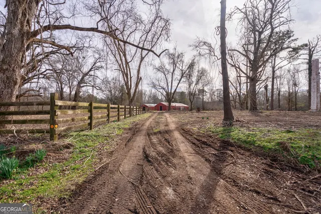 a view of a yard with wooden fence