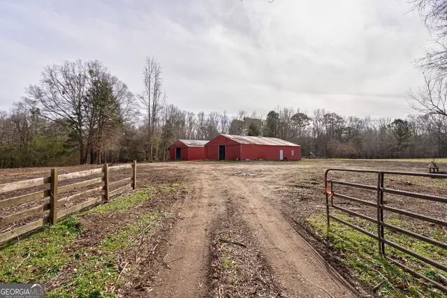 a view of a yard with wooden fence