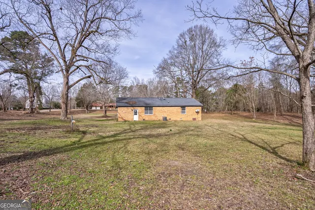 an aerial view of a houses with a yard