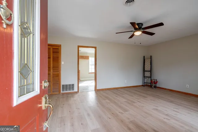 wooden floor in an empty room with a window